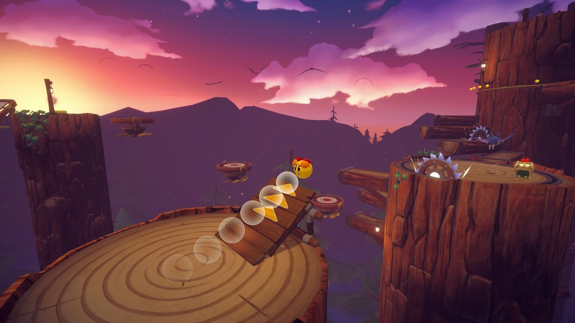 パックマンが木製の足場をジャンプで進む、夕焼けの美しいゲームプレイ画面。