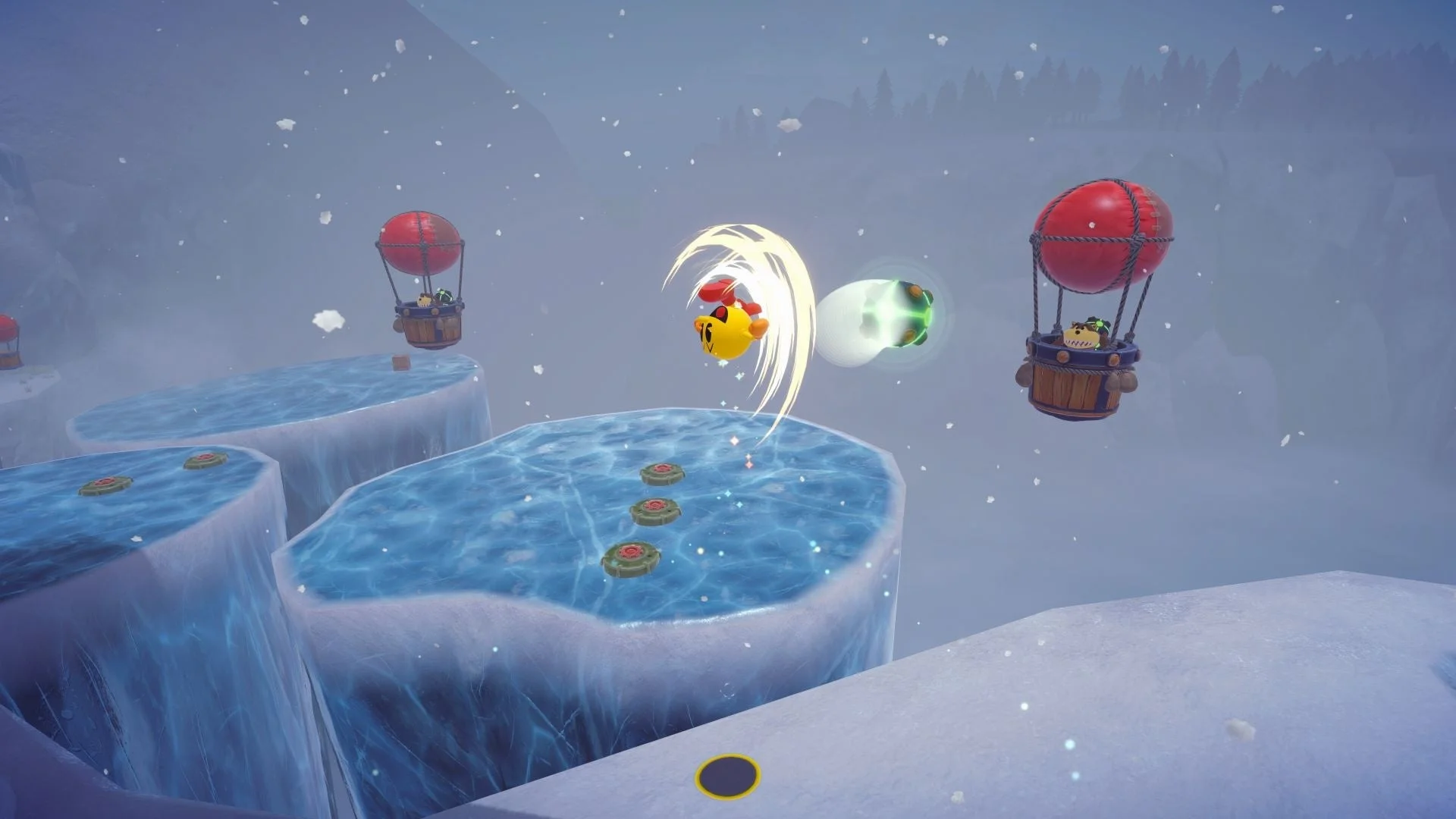 パックマンが雪山のステージでジャンプし、敵をかわすゲームプレイ画面。