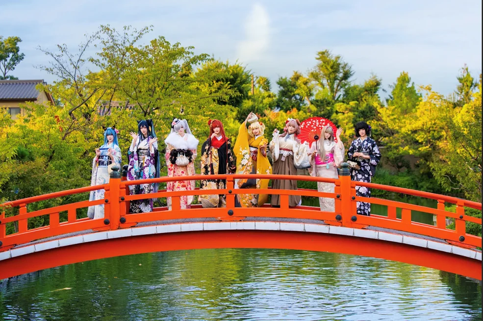 紅葉が美しい橋の上でポーズをとる公式コスプレイヤーたち