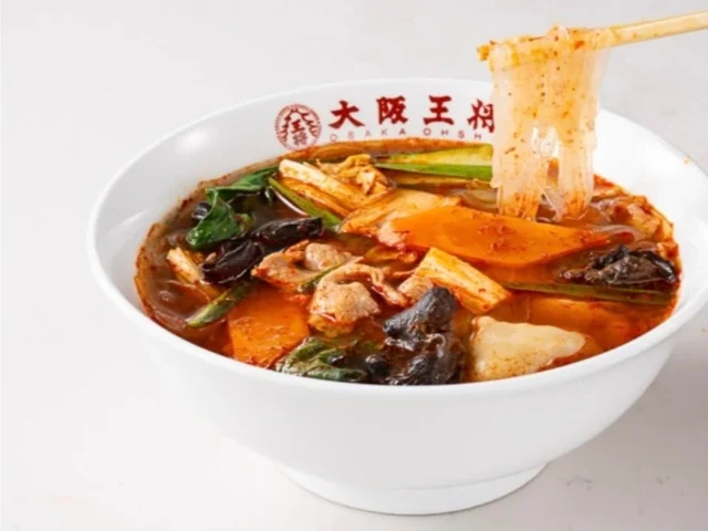 大阪王将 魅惑の五香麻辣湯(春雨麺)を箸で持ち上げた写真。