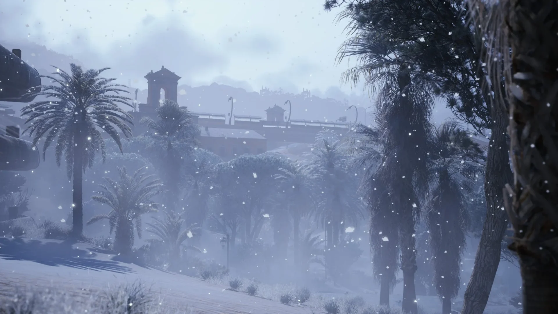 雪が舞うCold Snapマップの遠景、ヤシの木と建物