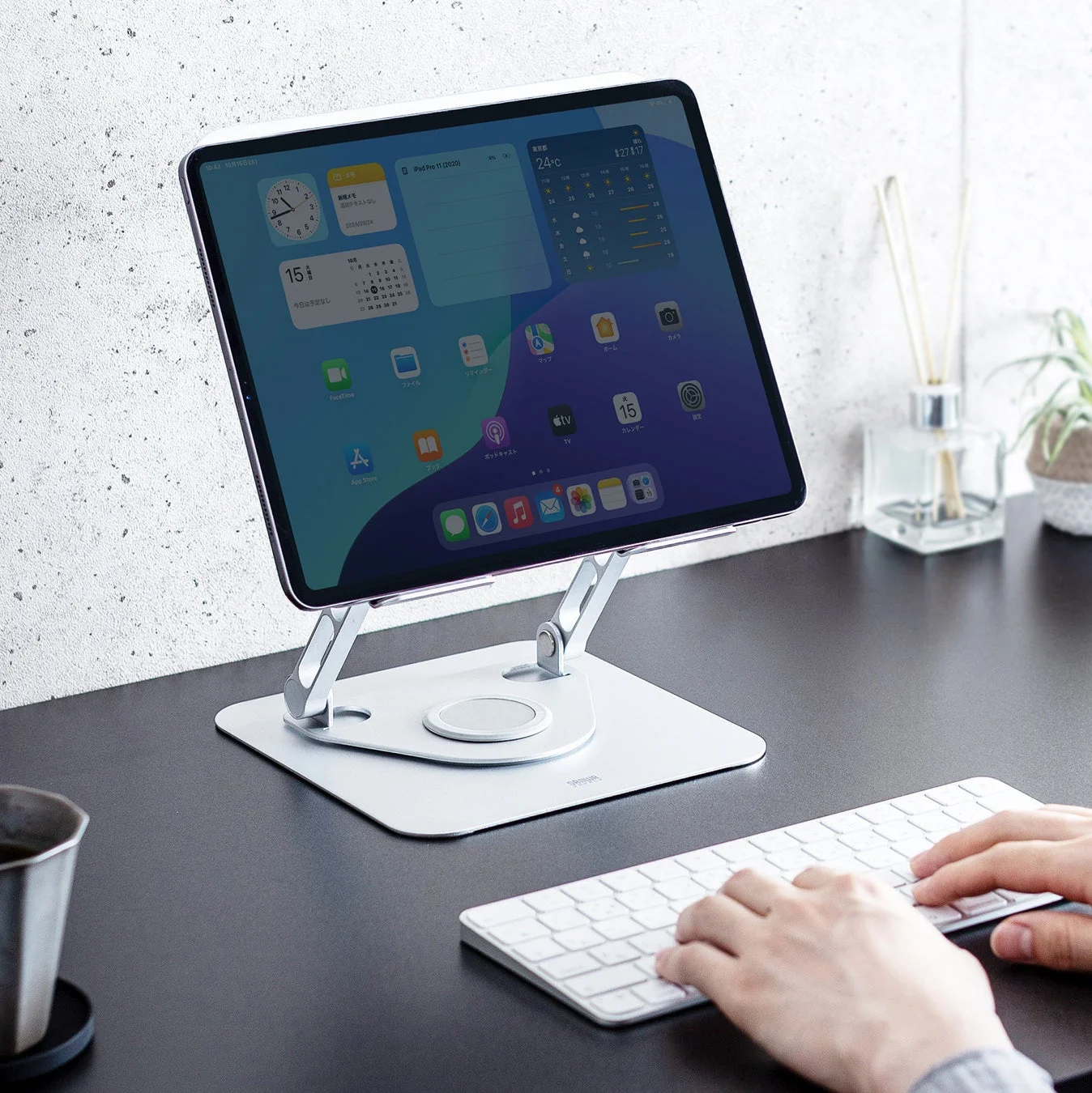 ノートパソコンスタンドにタブレットを設置しキーボードで操作する様子