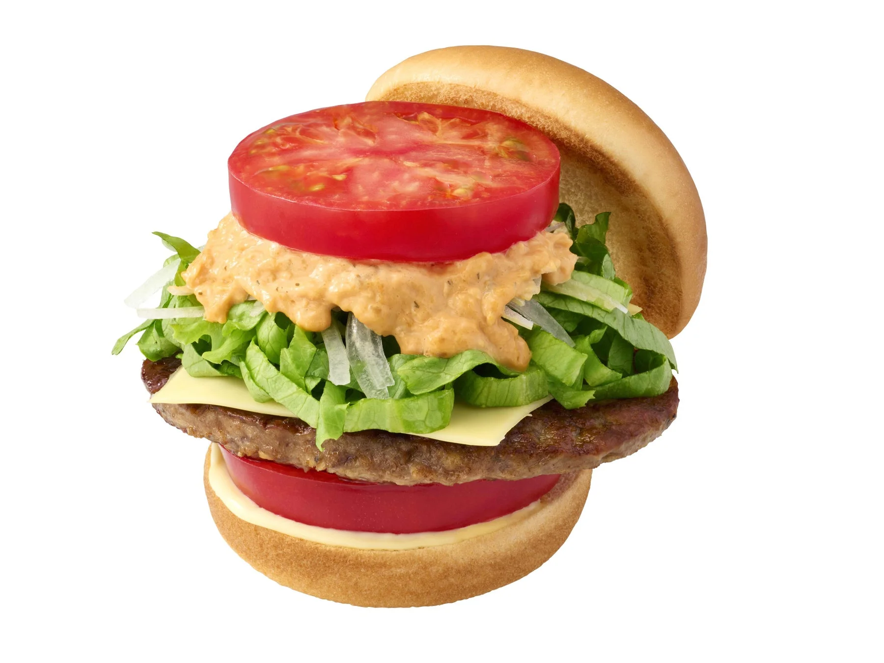 新とびきり 大盛りトマト モス野菜チーズバーガーのクローズアップ写真。