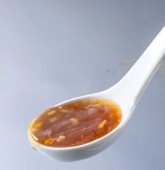 スプーンに乗せられた共同開発の濃厚豚スープだし