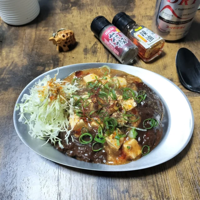 麻婆豆腐の重ねがけトッピング。ゴーゴーカレーに麻婆豆腐とネギが添えられている