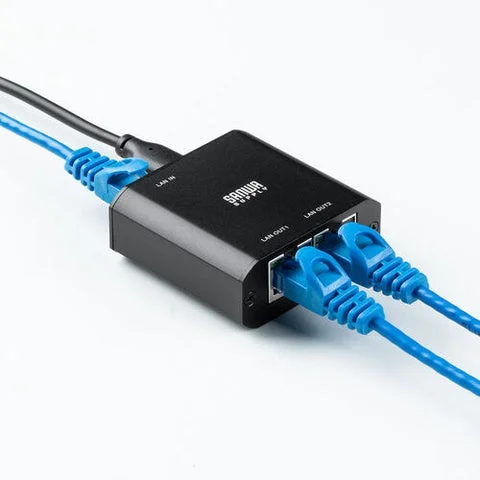 LANケーブルが接続された超小型スイッチングハブのクローズアップ