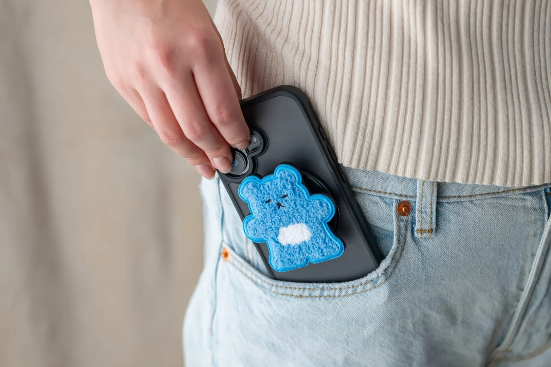 MagSafe対応Griptok（クマ柄）を装着したスマホをポケットに収納する様子